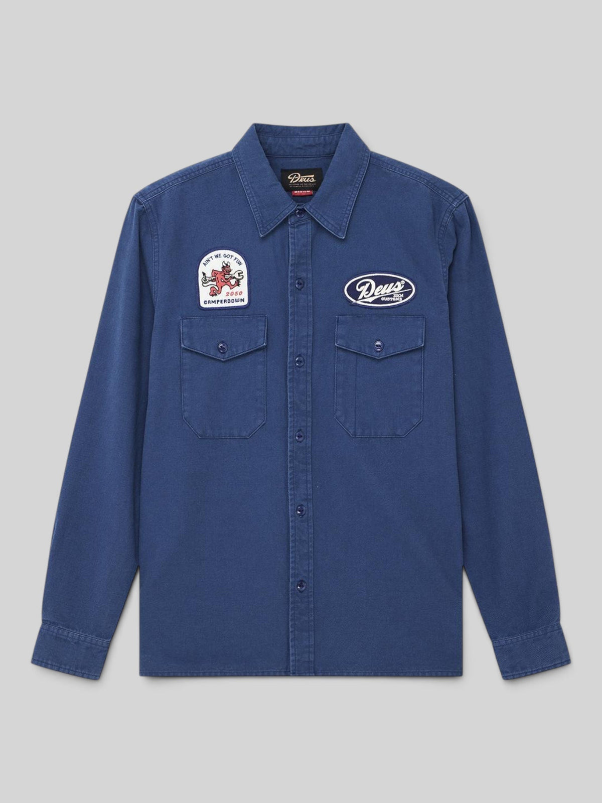 Baffle Haus Nomad shirt in mechanic blue cotton twill with chest pockets and embroidered patches