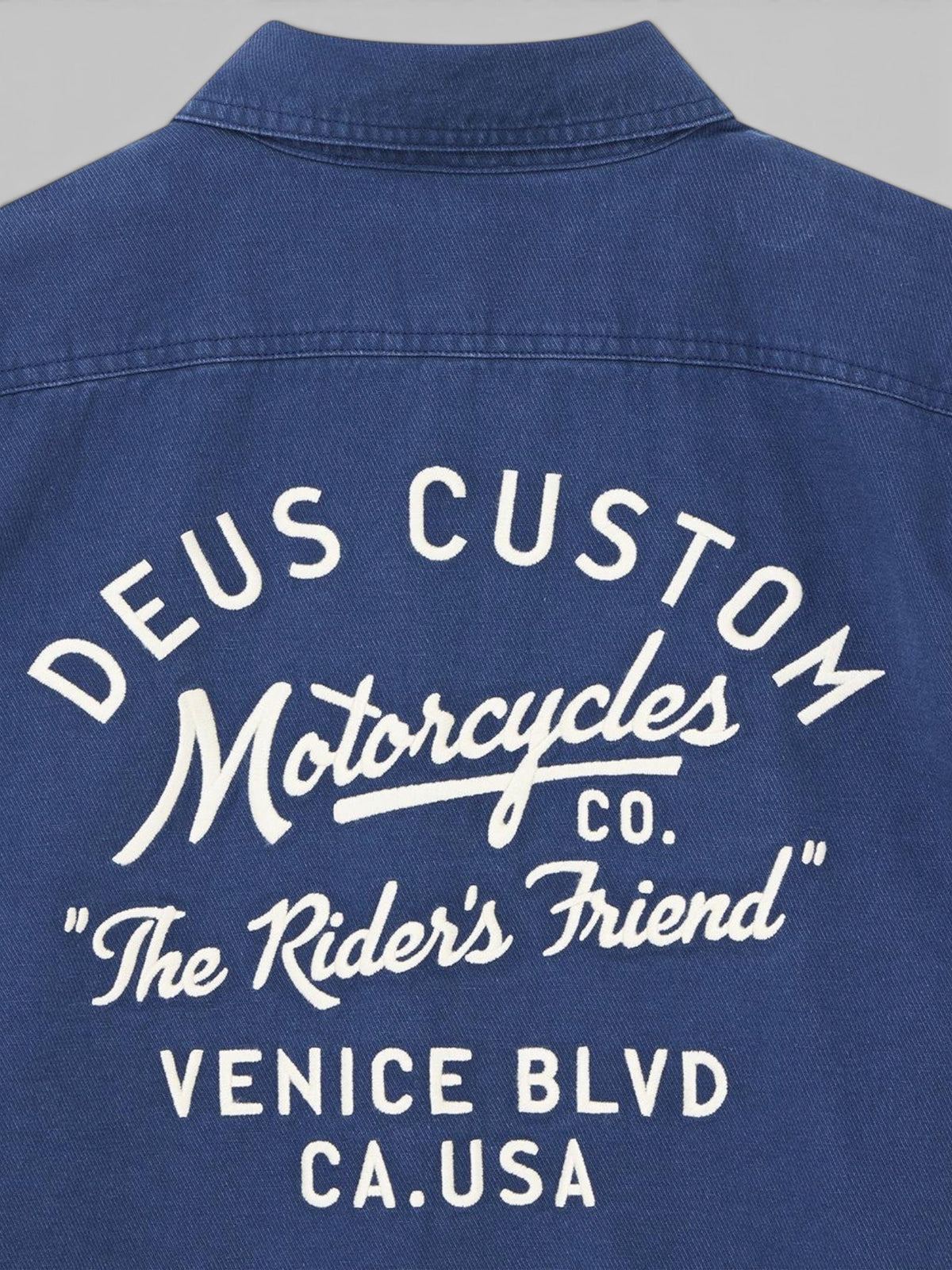 Baffle Haus Nomad shirt in mechanic blue cotton twill featuring white embroidered Deus Custom Motorcycles back art