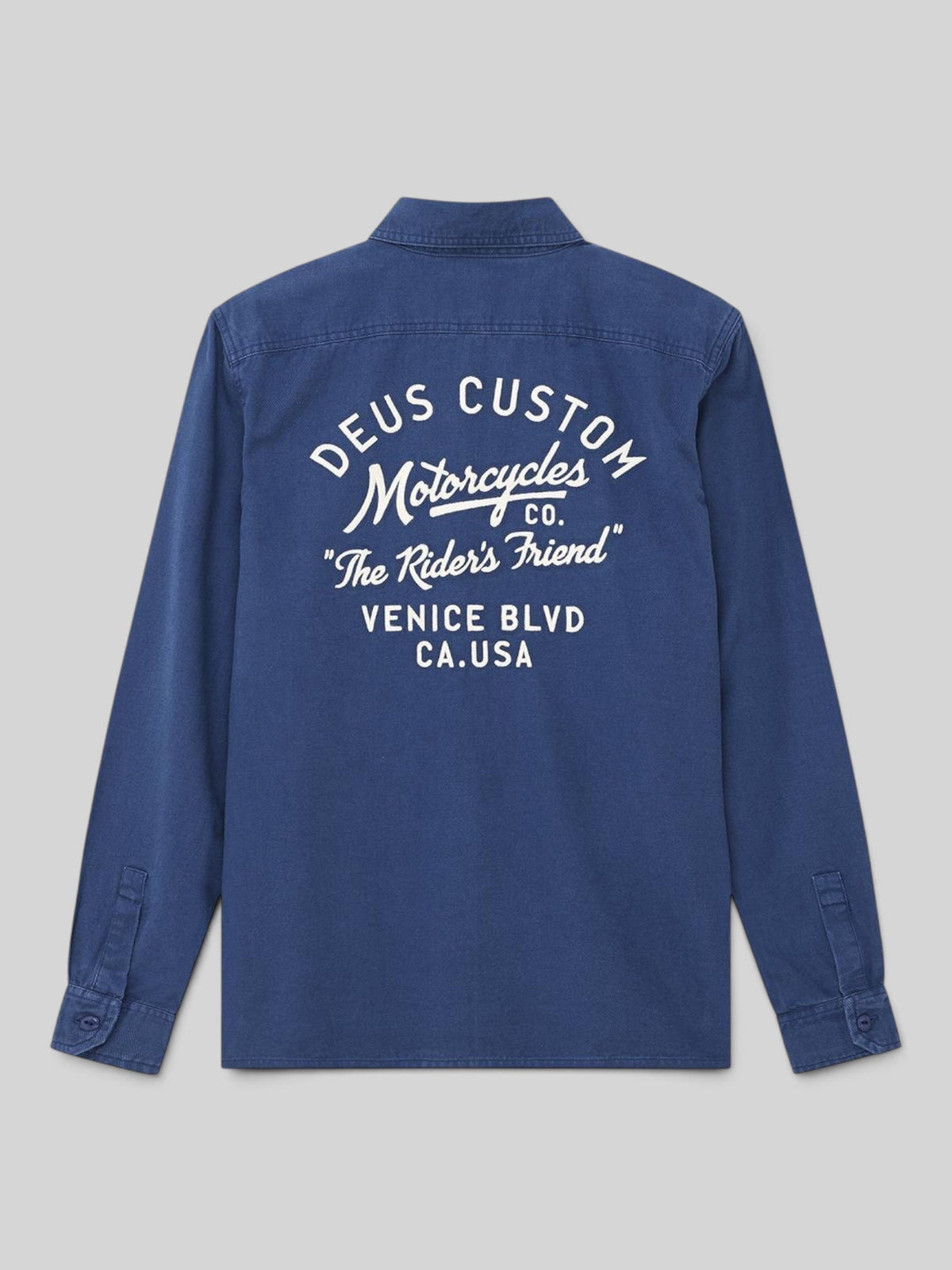 Baffle Haus Nomad shirt in mechanic blue cotton twill with white embroidered Deus motorcycle graphics on the back