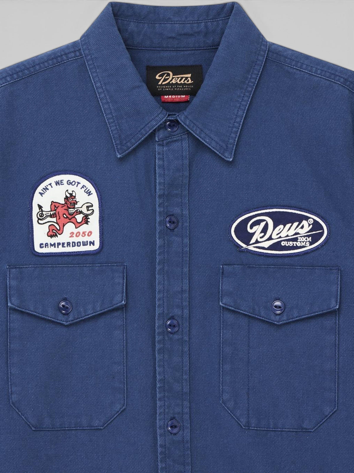 Baffle Haus Nomad shirt in mechanic blue cotton twill featuring embroidered patches and chest pockets