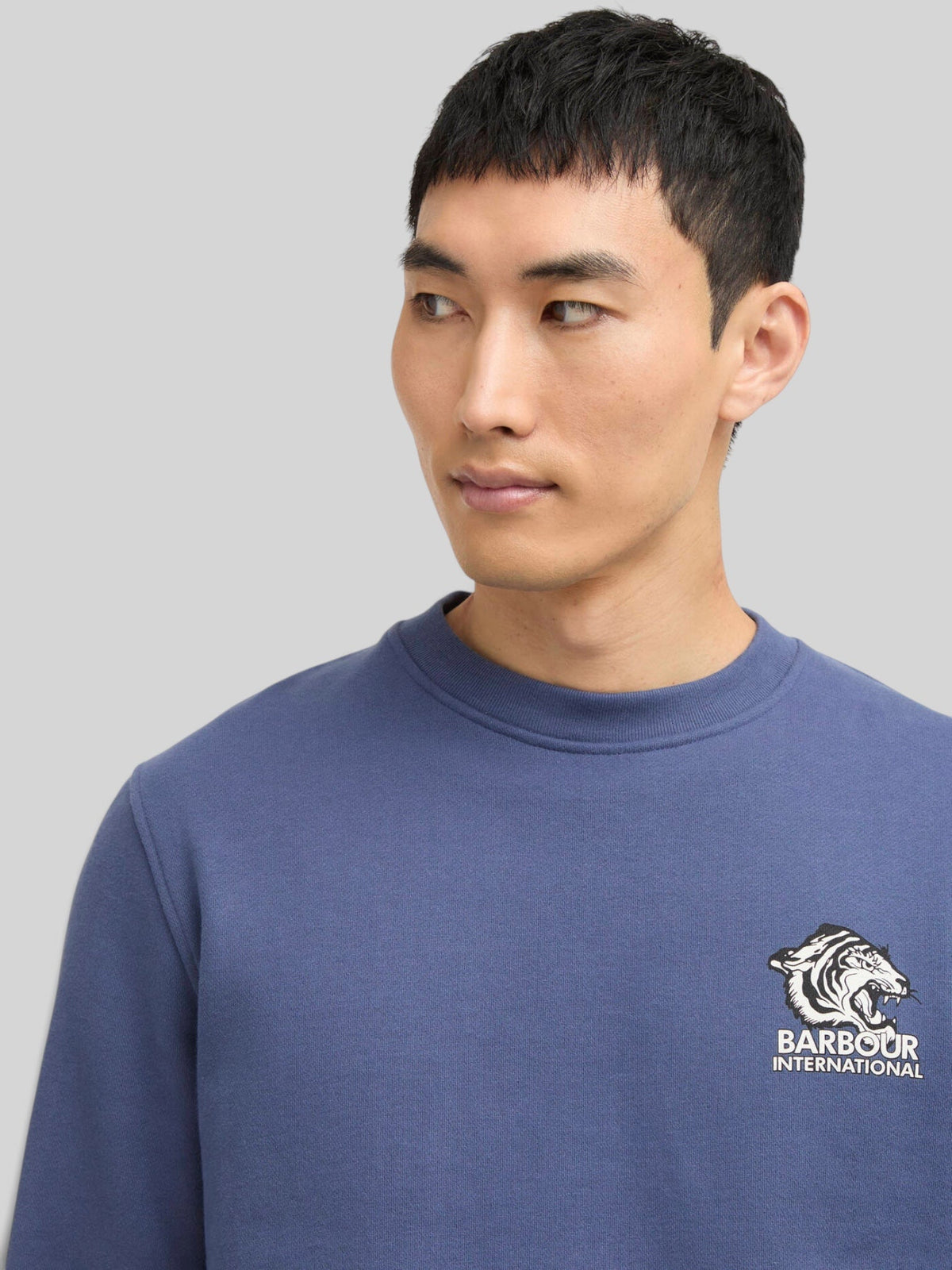 Baffle Haus B.Intl Talisman graphic sweatshirt in Oceana blue cotton fleece with chest logo on a male model