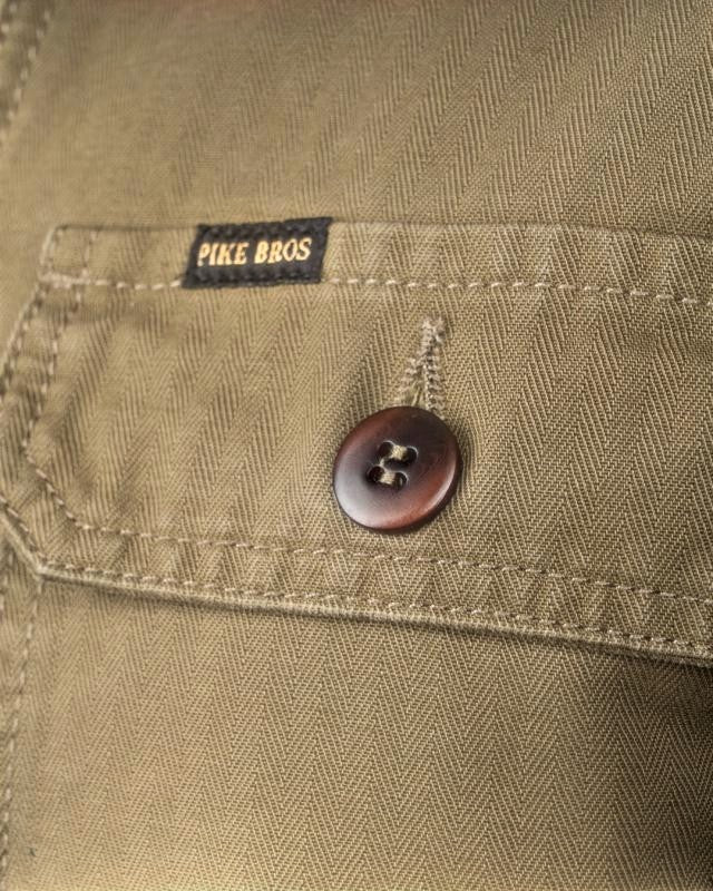 Baffle Haus olive 1967 utility shirt in heavyweight herringbone twill fabric with a buttoned chest pocket detail.