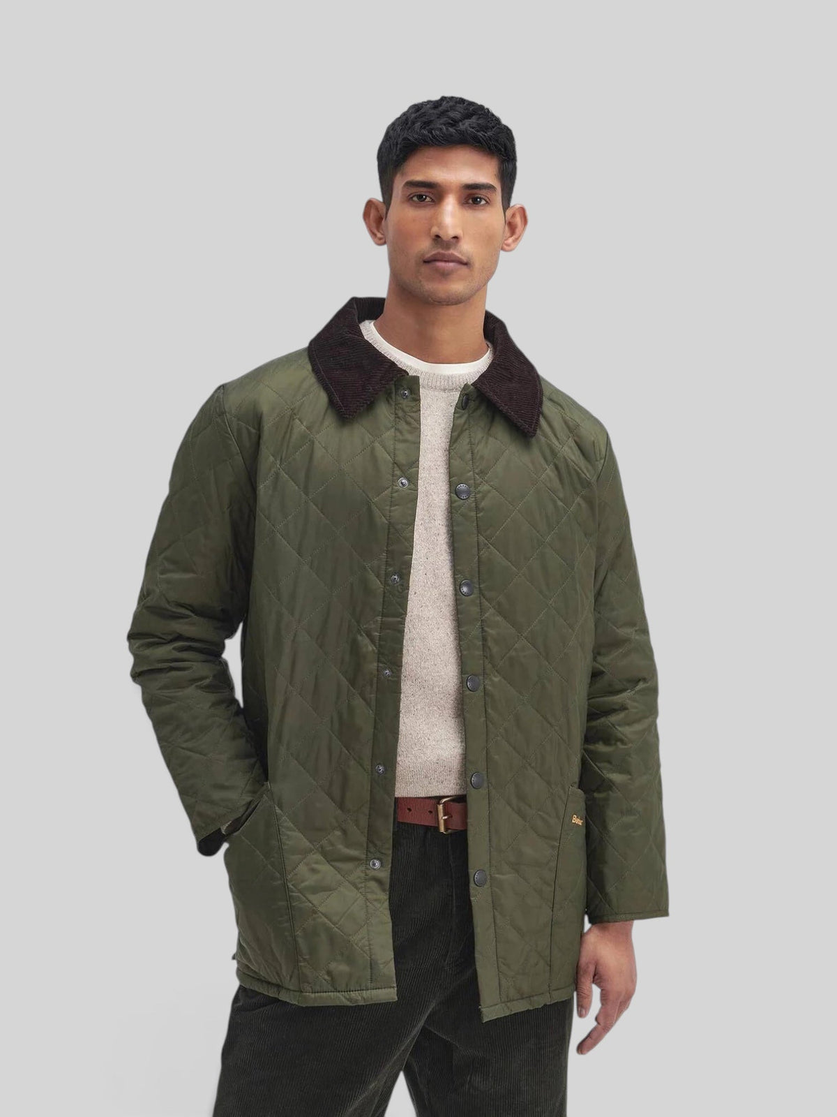 Baffle Haus Heritage Liddesdale olive green quilted jacket with a brown corduroy collar and snap-button front.