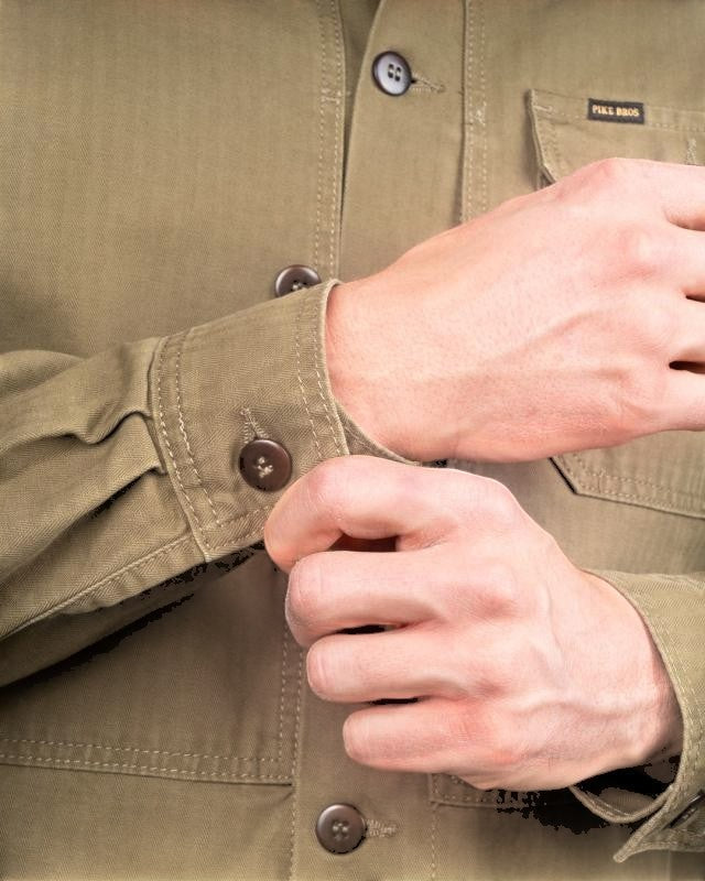 Baffle Haus 1967 Utility Shirt in olive herringbone twill cotton with reinforced cuffs and button details