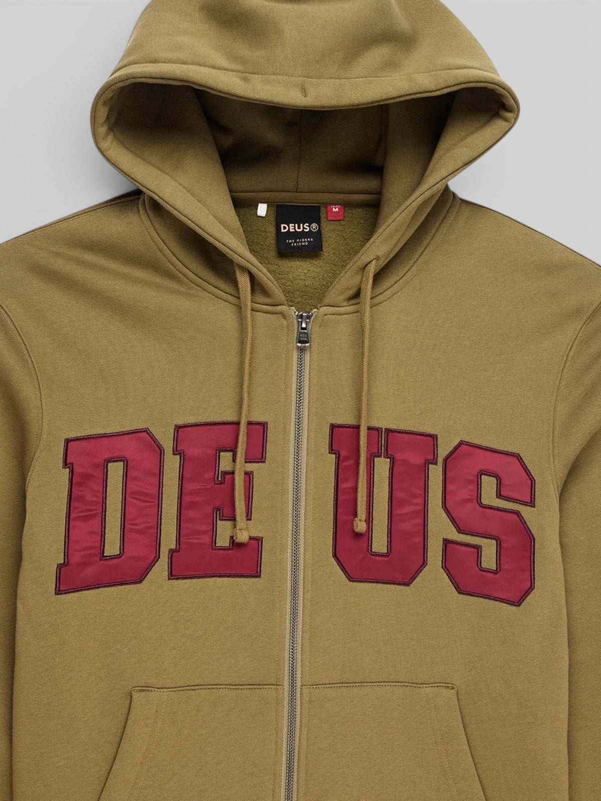 Baffle Haus olive green zip-up hoodie featuring maroon twill applique lettering on the chest and a drawstring hood.