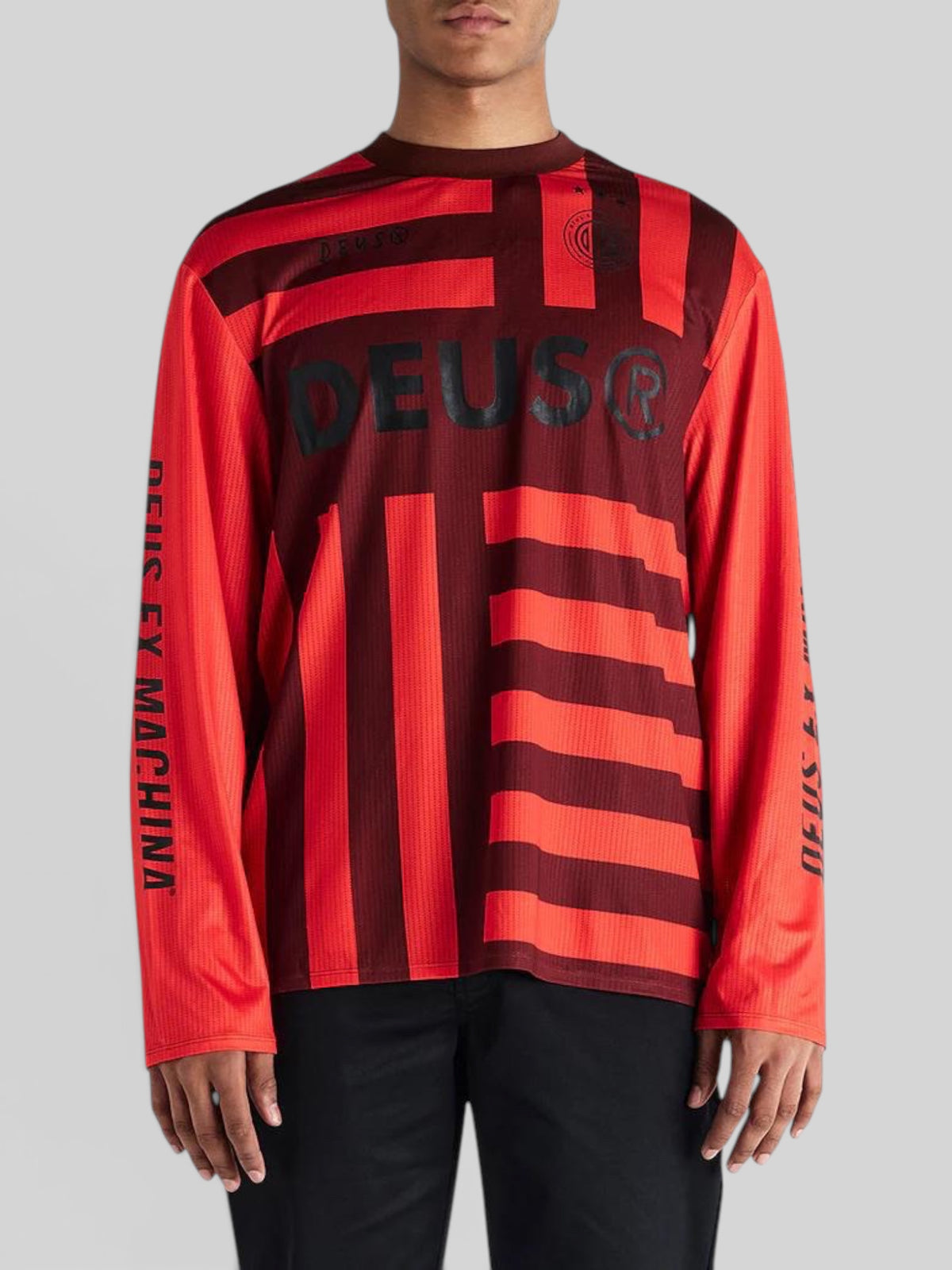 Baffle Haus Blackout Moto Jersey in orange and dark red with Deus Ex Machina branding and long sleeves