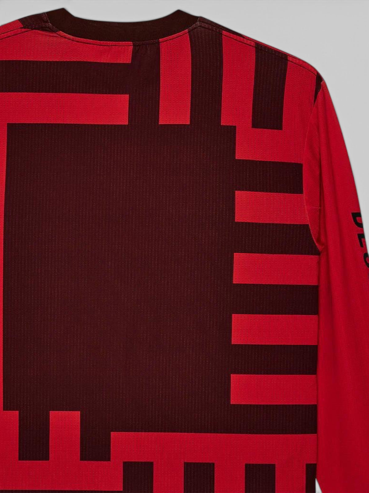 Baffle Haus Blackout Moto Jersey in orange and dark red with geometric graphic patterns and long sleeves