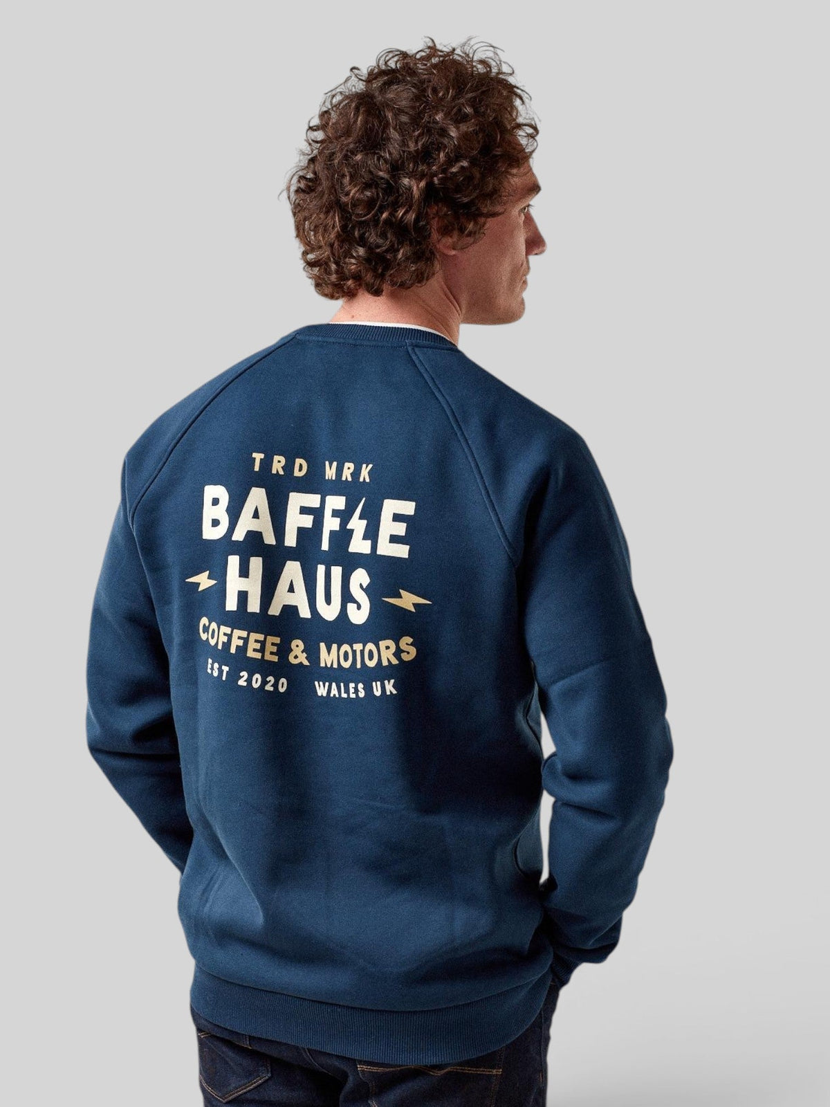 Model wearing a Baffle Haus pageant blue heavyweight cotton blend sweatshirt with Coffee & Motors back graphic print