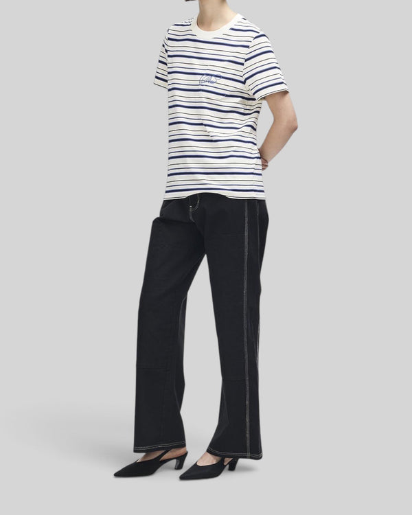 Baffle Haus Pierre stripe tee in cream and blue with contrast embroidery on the chest pocket, worn by a model.