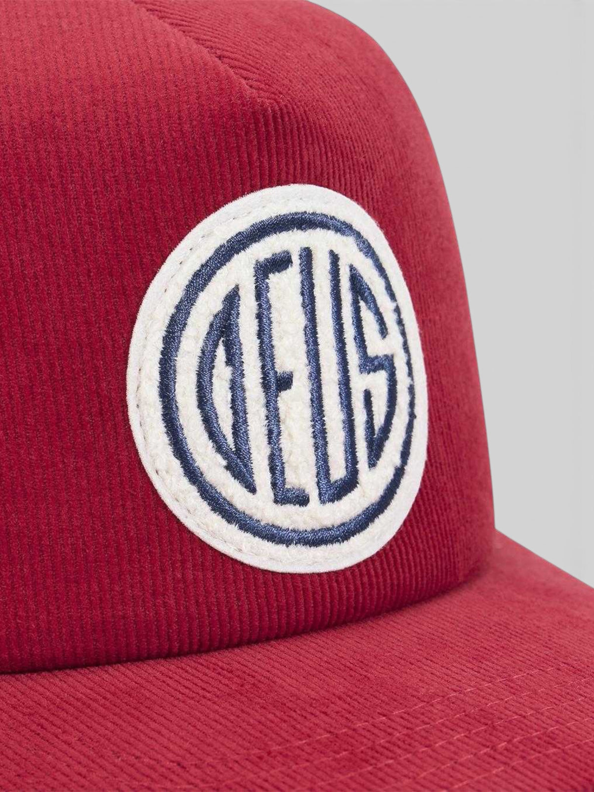 Baffle Haus Pill Cord Trucker hat in ribbon red cotton corduroy with a circular embroidered front logo patch