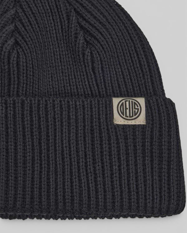 Baffle Haus Pill Merino Beanie in black featuring a ribbed knit texture, double fold turnover, and branded label.
