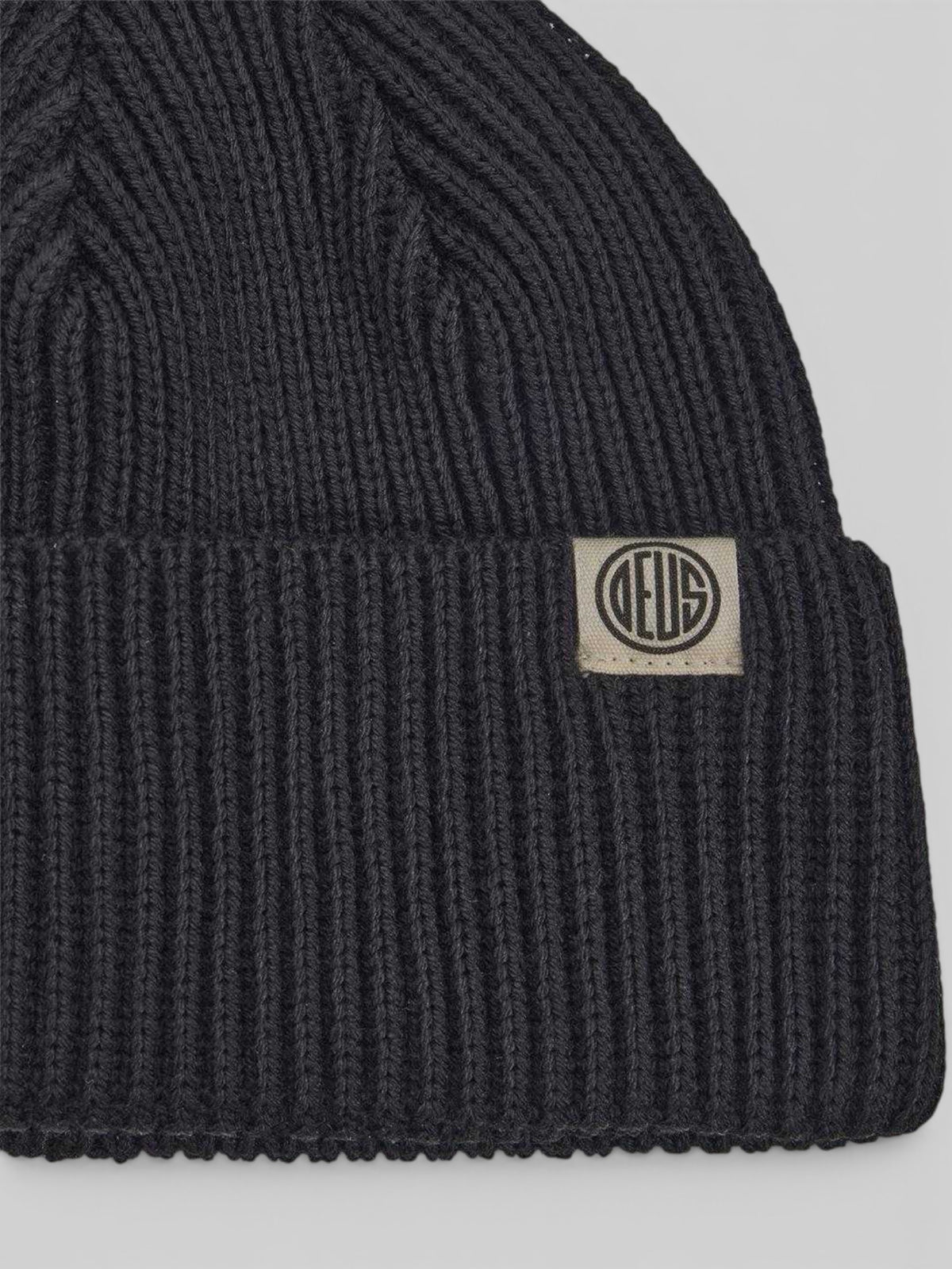 Baffle Haus Pill Merino Beanie in black featuring a ribbed knit texture, double fold turnover, and branded label.