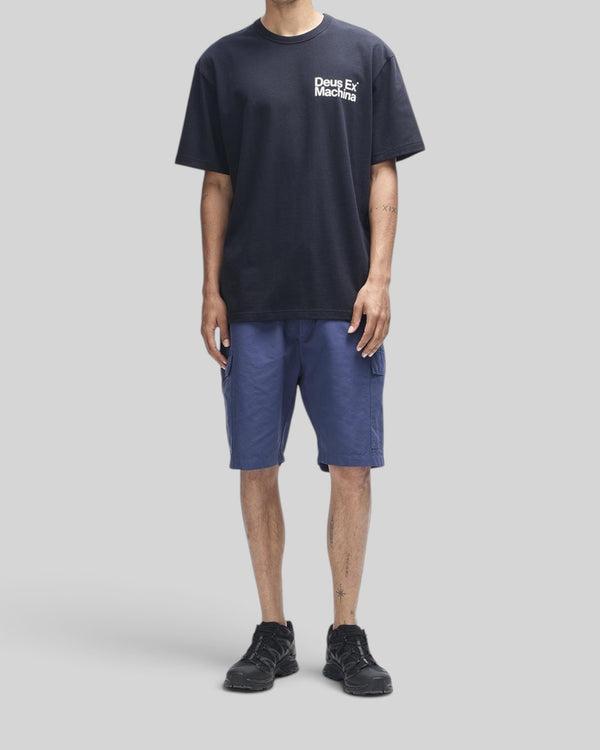 Baffle Haus Plenty Good Tee in black organic cotton with chest graphic, worn by a model with blue cargo shorts.