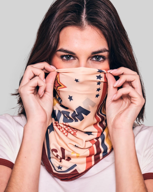 Baffle Haus Pole Position scarf featuring vintage motorcycle racing motifs like swallows and flags worn over the face