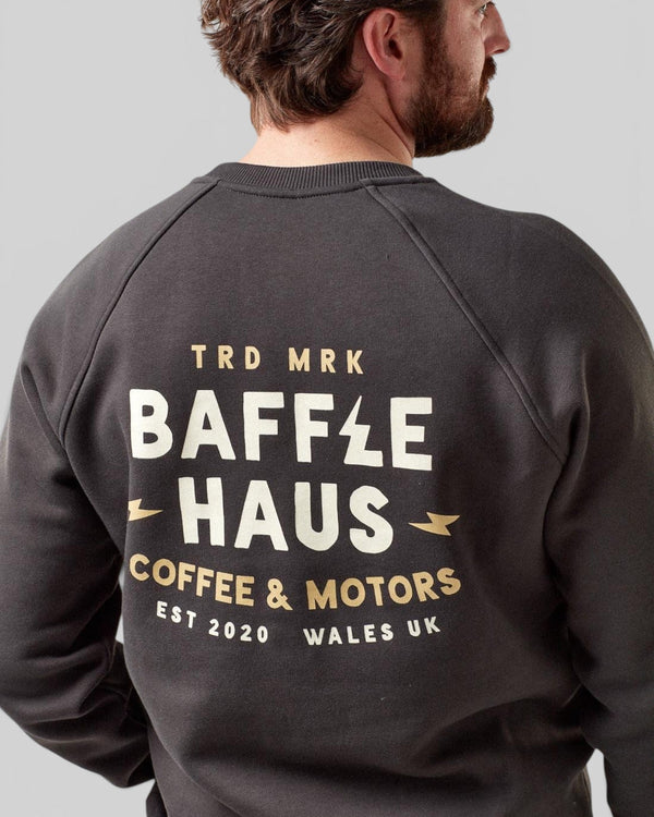 Baffle Haus Coffee & Motors sweatshirt in printers ink grey with back graphic print worn by a man