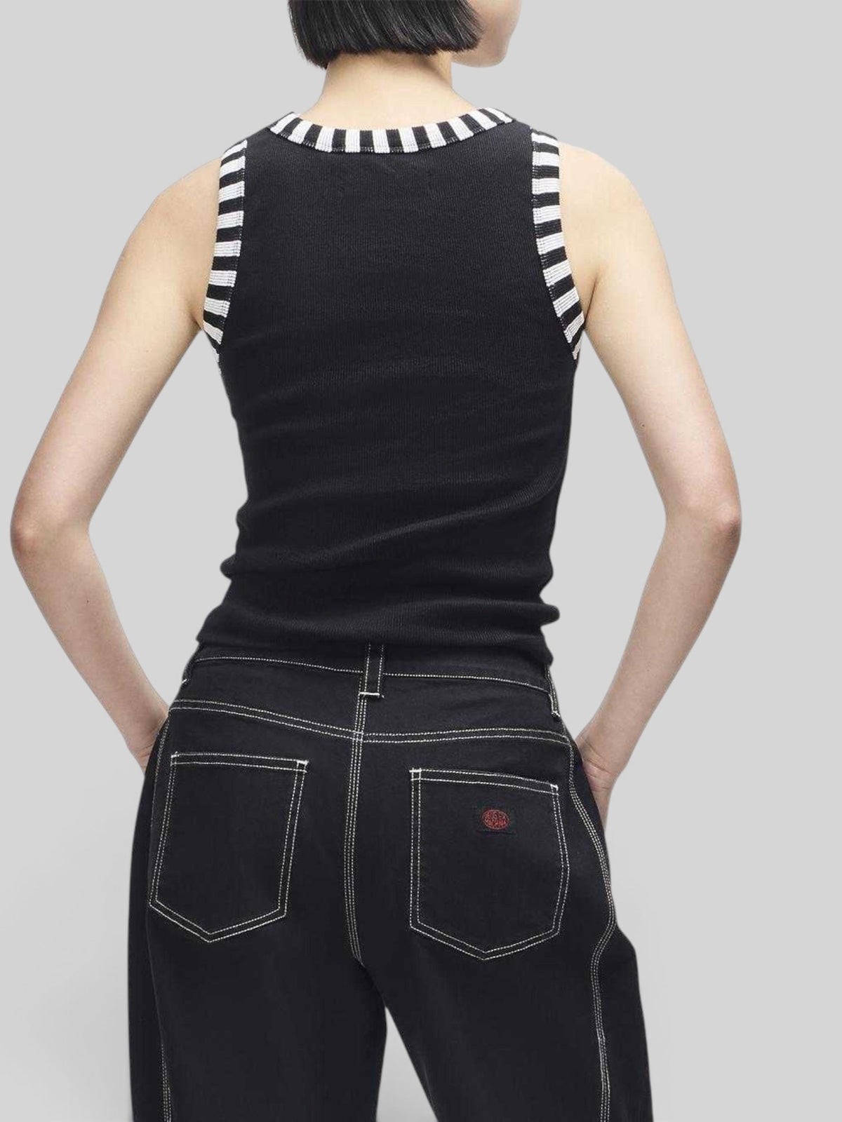 Baffle Haus Rally Shield black ribbed tank top with contrast white and black striped neck and arm trim, back view