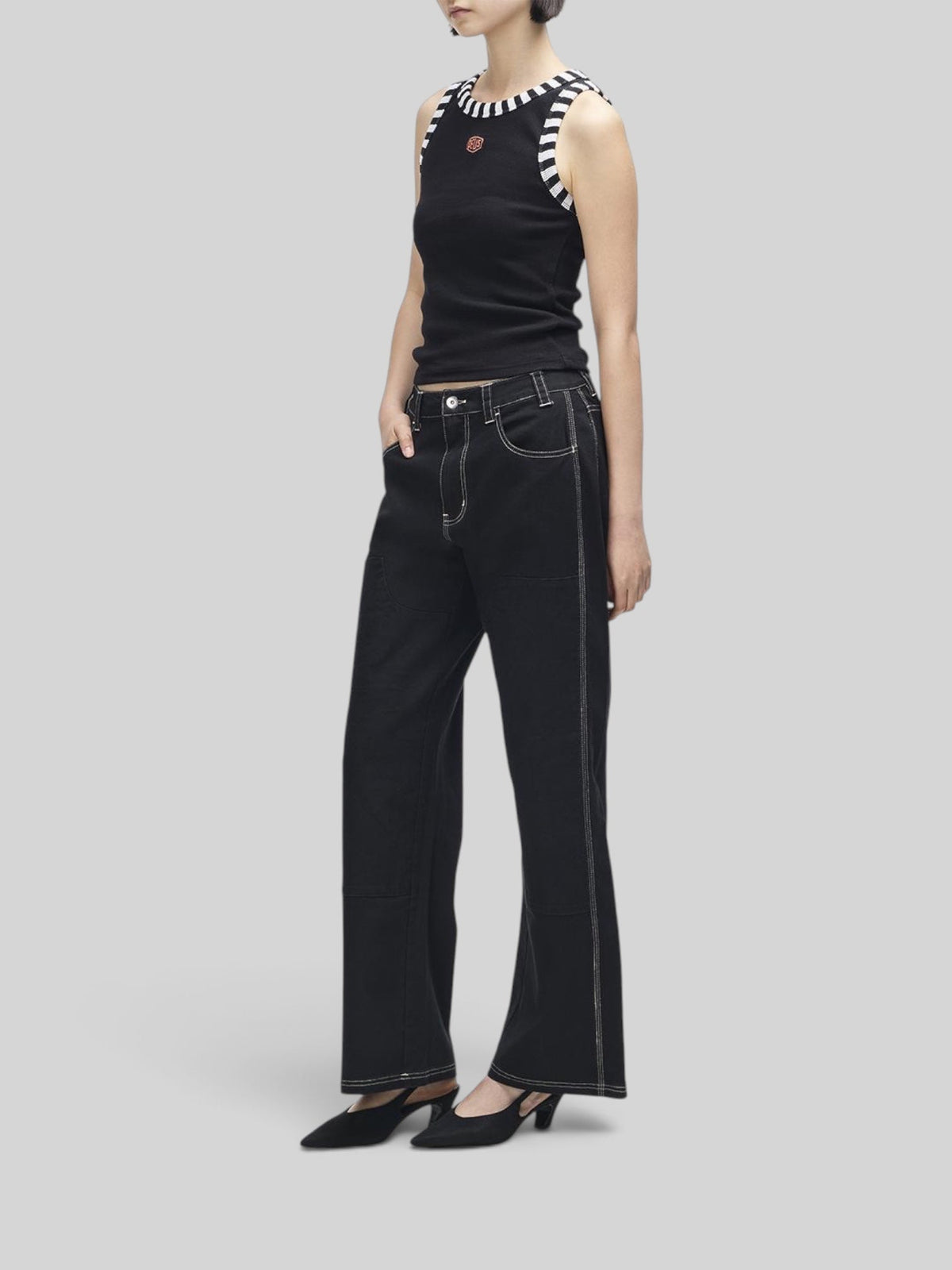 Baffle Haus Rally Shield black ribbed tank top with contrast striped neck and armhole trim worn by a model