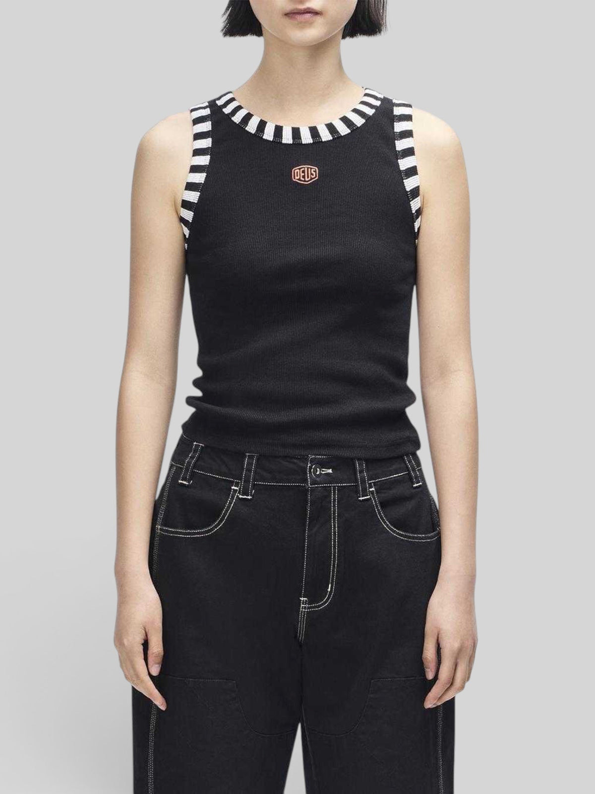 Baffle Haus Rally Shield black ribbed tank top with contrast striped neck and armhole trim and Deus shield embroidery.