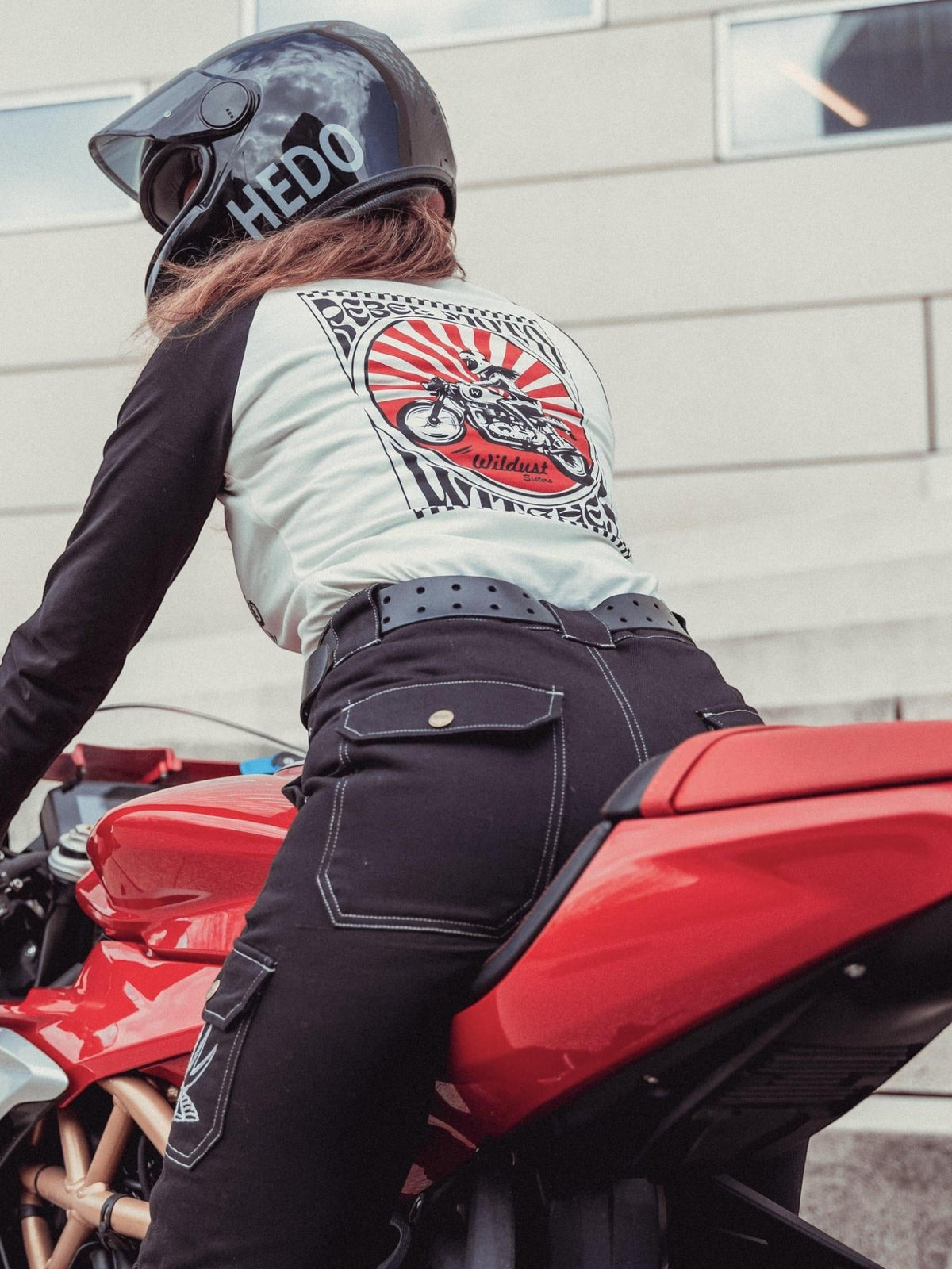 Baffle Haus Rebel long sleeve tee with graphic print on back, worn by a motorcyclist on a red sportbike