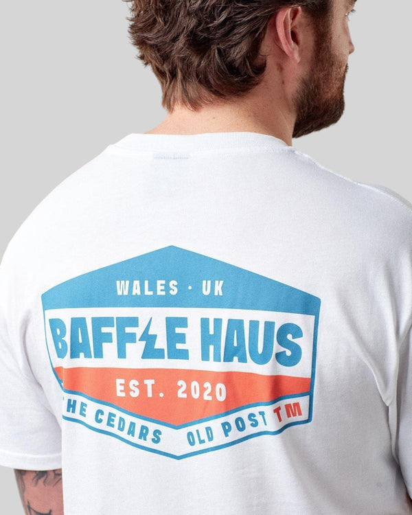 Baffle Haus white cotton t-shirt featuring a retro-inspired blue and orange graphic on the back