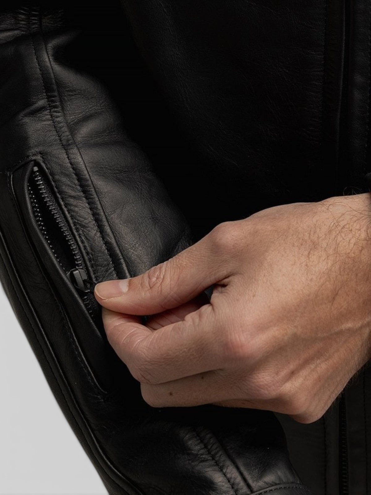 Baffle Haus Revolver black cowhide leather motorcycle jacket featuring a zippered forearm stash pocket