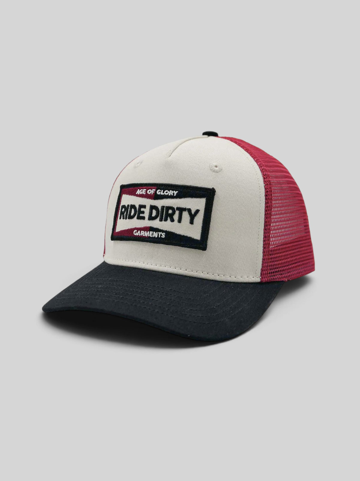 Baffle Haus Ride Dirty trucker cap in white, red, and black with a vintage patch and breathable mesh back.