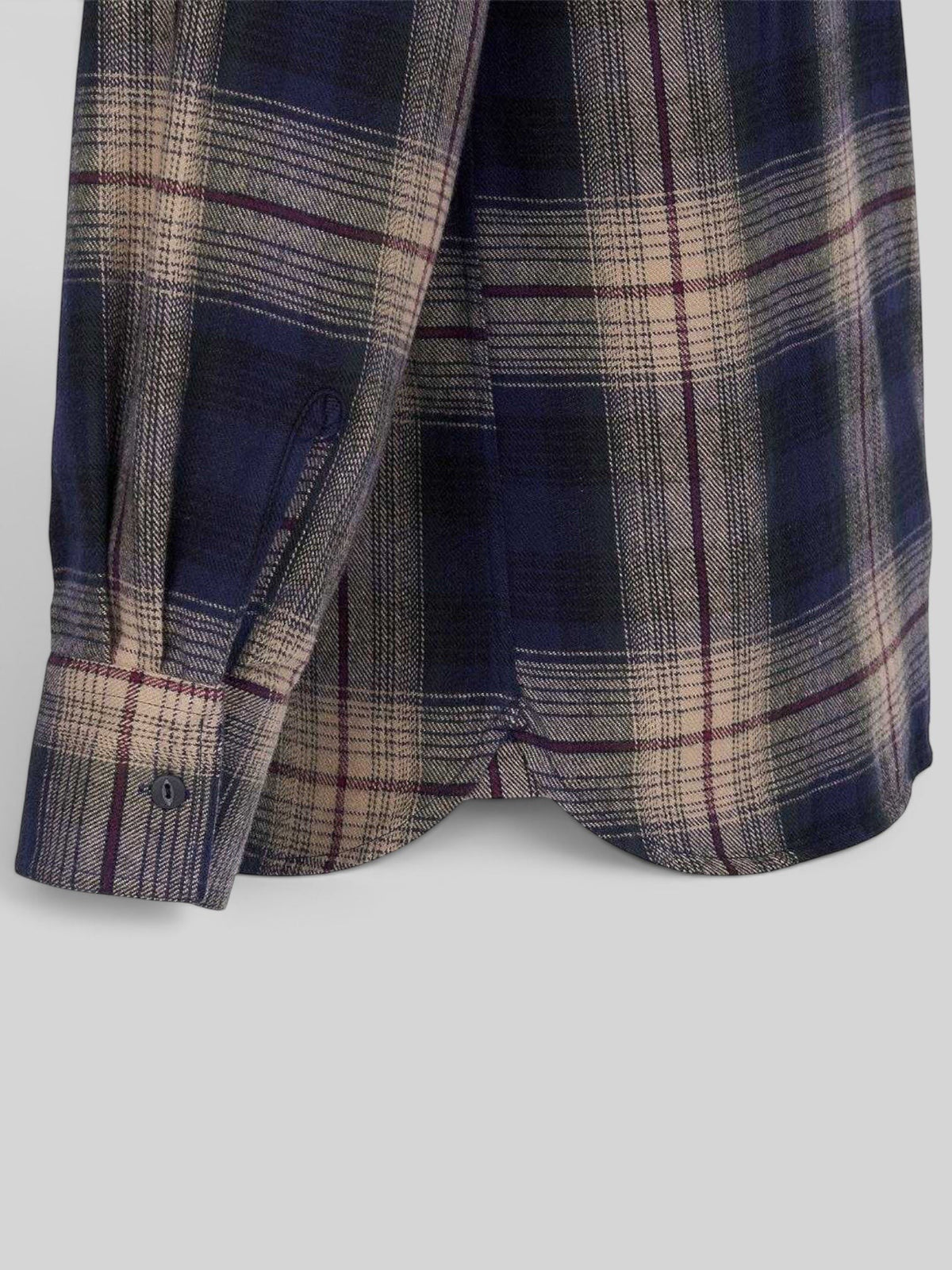 Baffle Haus 1937 Roamer Shirt in navy and beige plaid cotton with a curved hem and buttoned cuff detail.