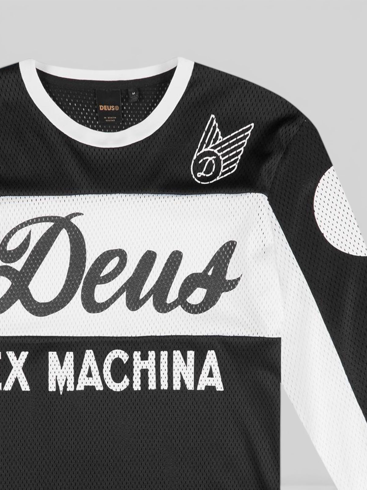 Baffle Haus Saber Moto Jersey in black and white polyester mesh with Deus wordmark and logo chest print