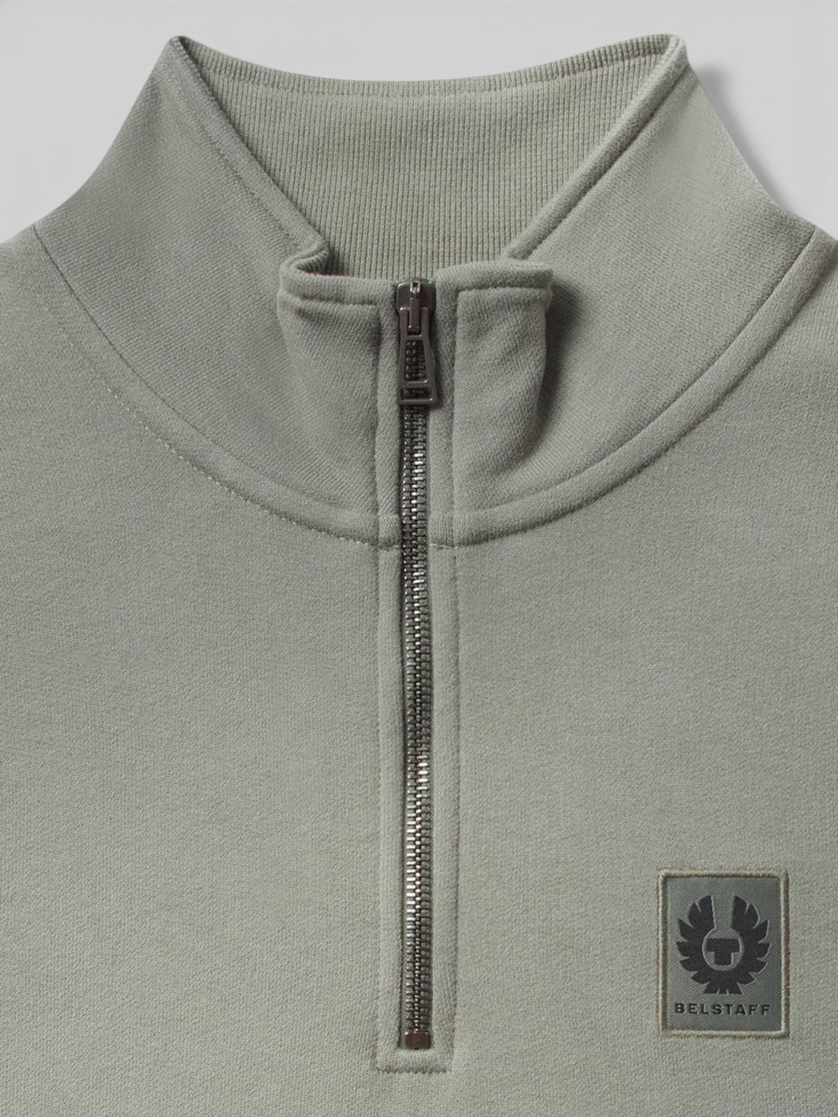 Baffle Haus sage green cotton quarter zip jersey featuring a ribbed collar and Belstaff phoenix logo chest patch.