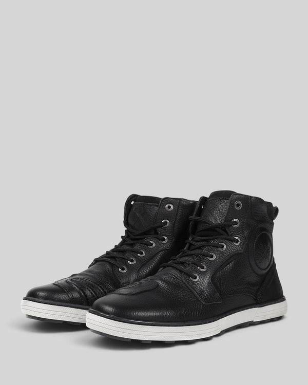 Baffle Haus Shifter black leather motorcycle sneaker boots with gearshift protection and white non-slip soles.
