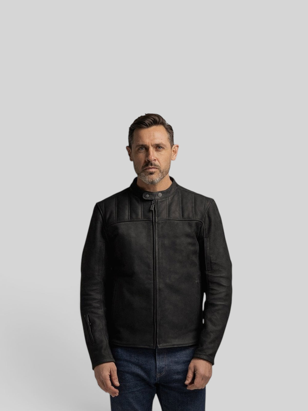 A man wearing a Baffle Haus Shōgun black nubuck leather motorcycle jacket with quilted chest panels and zip pockets.