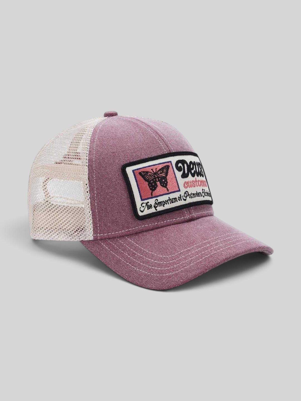 Baffle Haus Slapstick Trucker hat in melon red with a white mesh back, unstructured crown, and butterfly patch.