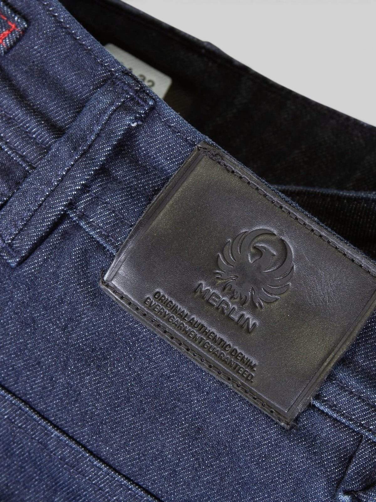 Baffle Haus Soho ladies blue denim motorcycle jeans featuring a black leather brand patch with embossed logo