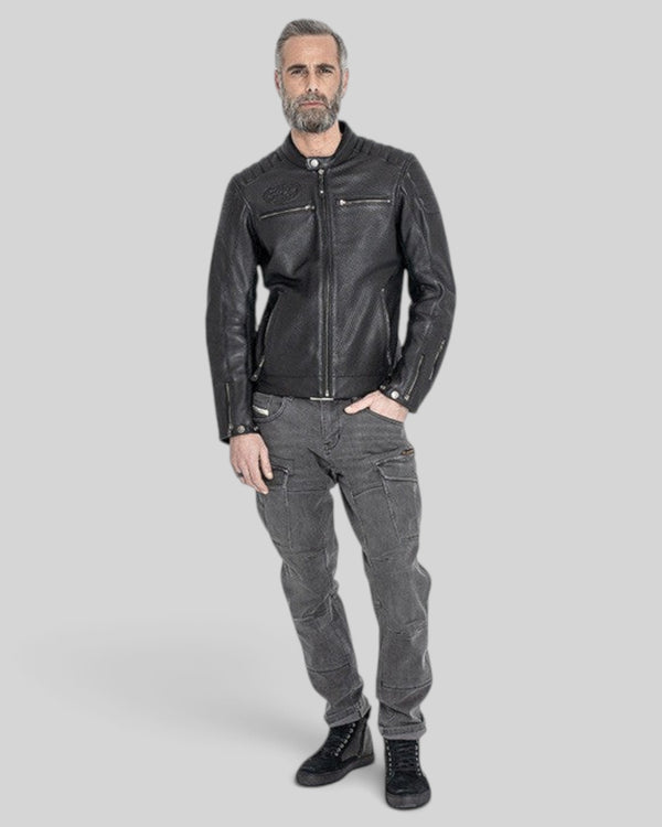 Baffle Haus Storm black perforated leather motorcycle jacket worn by a man with grey hair and beard