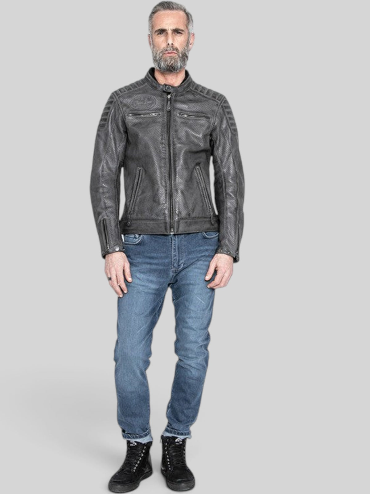 Baffle Haus Storm grey perforated leather motorcycle jacket with padded shoulders and zip pockets on a male model