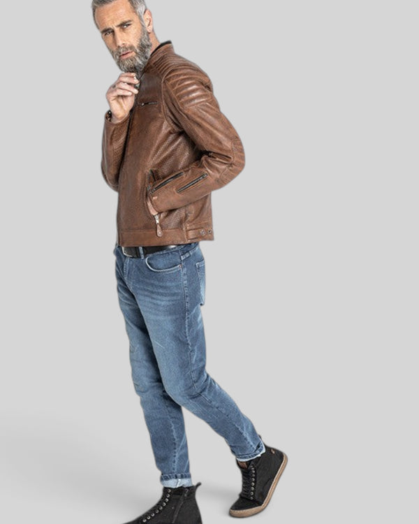 Baffle Haus Storm tobacco perforated leather motorcycle jacket with padded shoulders worn by a bearded model