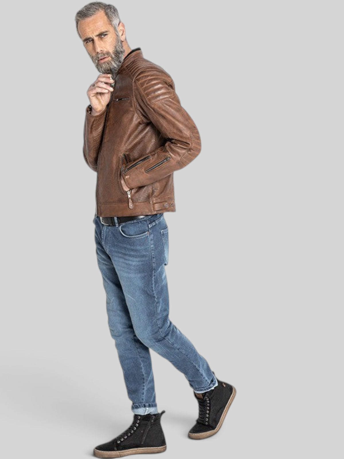 Baffle Haus Storm tobacco perforated leather motorcycle jacket with padded shoulders worn by a bearded model