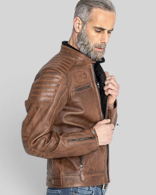 Baffle Haus Storm tobacco perforated leather motorcycle jacket with padded shoulders and YKK zippers on a model.