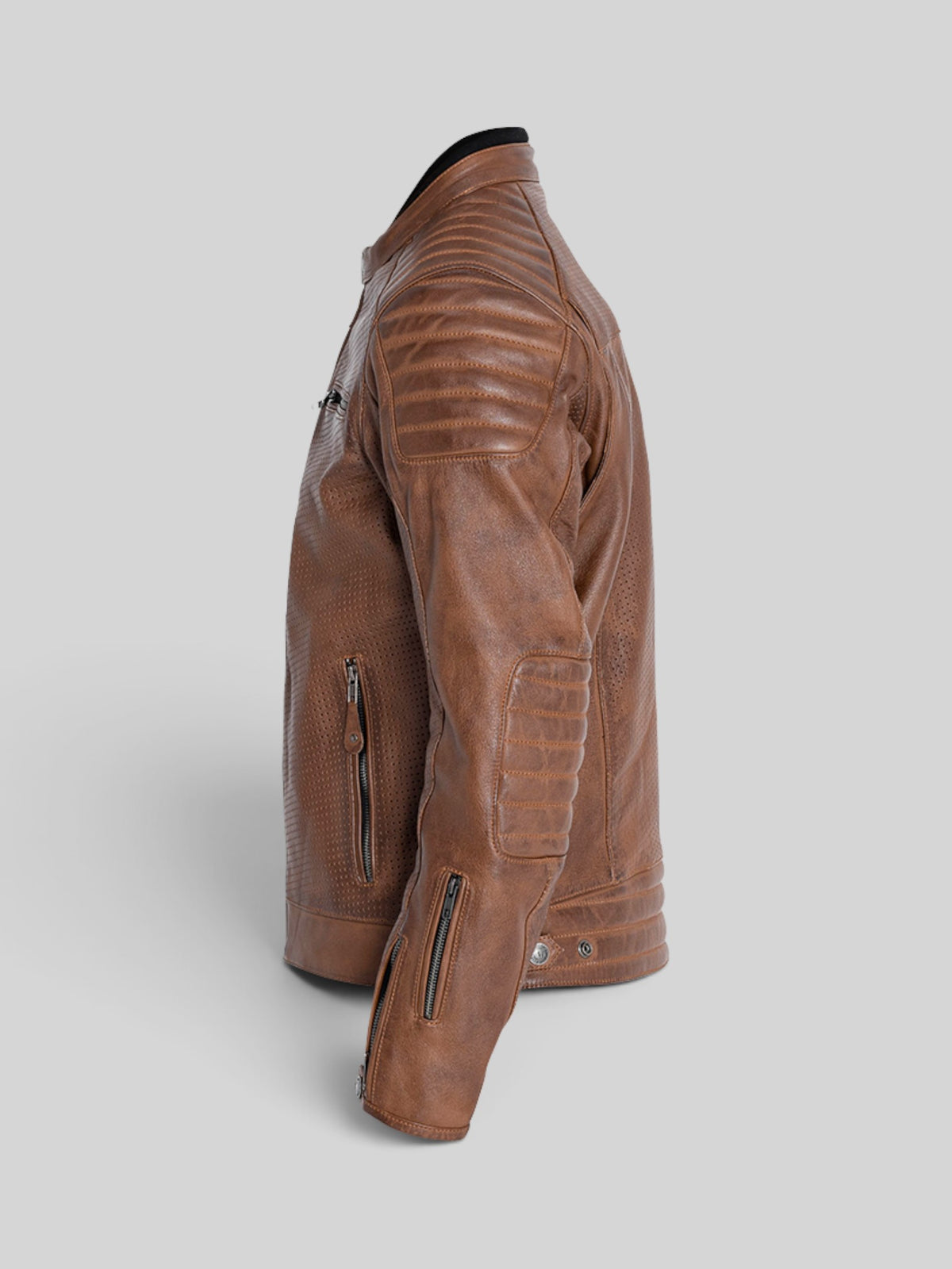 Baffle Haus Storm perforated tobacco leather motorcycle jacket with padded shoulders and zippered cuffs, side view.