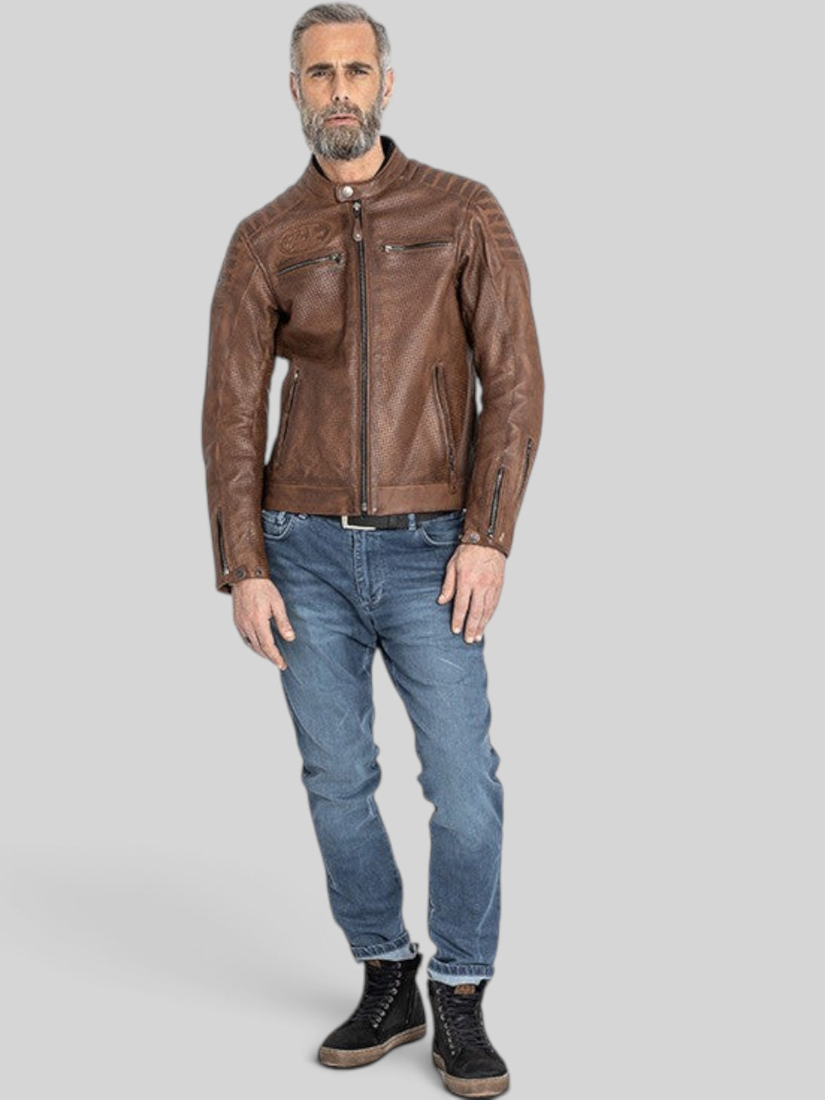 Baffle Haus Storm tobacco perforated leather motorcycle jacket with padded shoulders and zip pockets on a male model