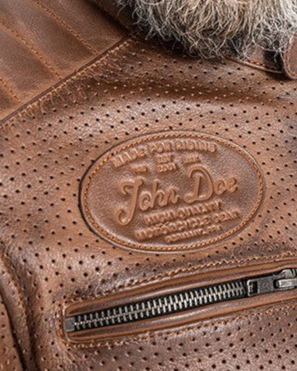Baffle Haus Storm tobacco perforated leather motorcycle jacket with embossed John Doe logo and zippered chest pocket