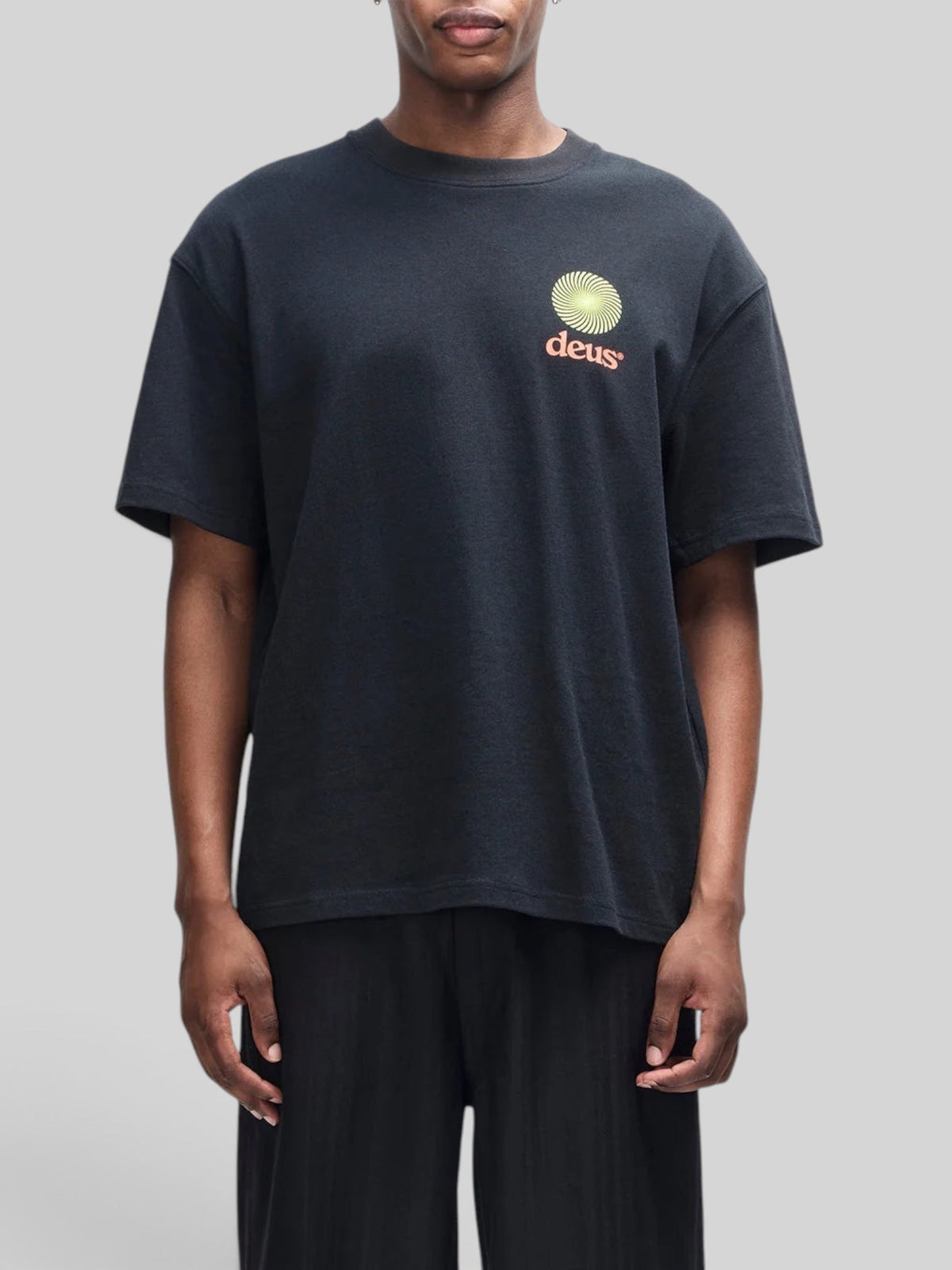Baffle Haus Strata Tee in black recycled cotton with a small graphic logo on the chest, featuring an oversized fit.