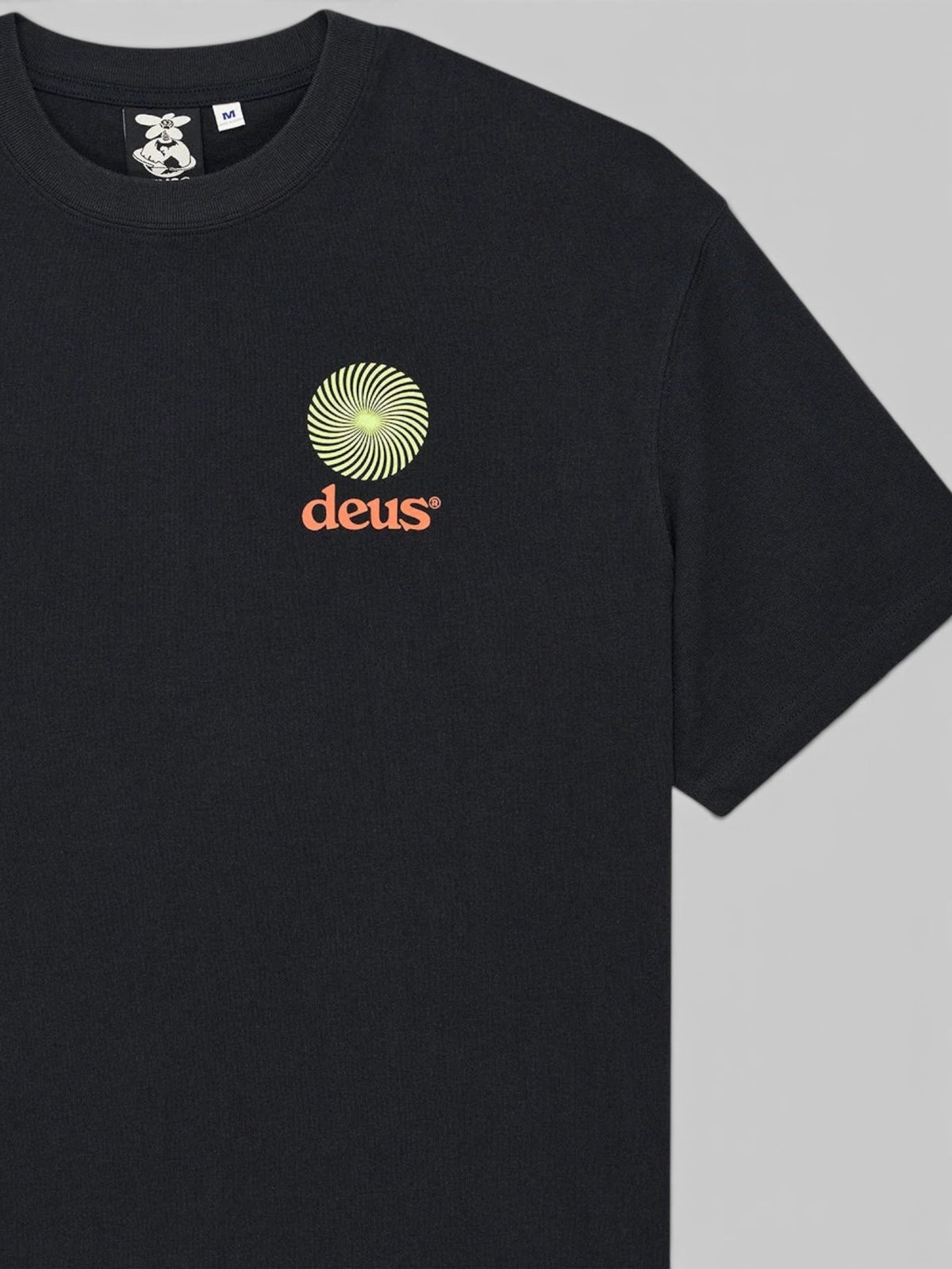 Baffle Haus Strata Tee in black recycled cotton with a yellow spiral graphic and orange logo on the chest