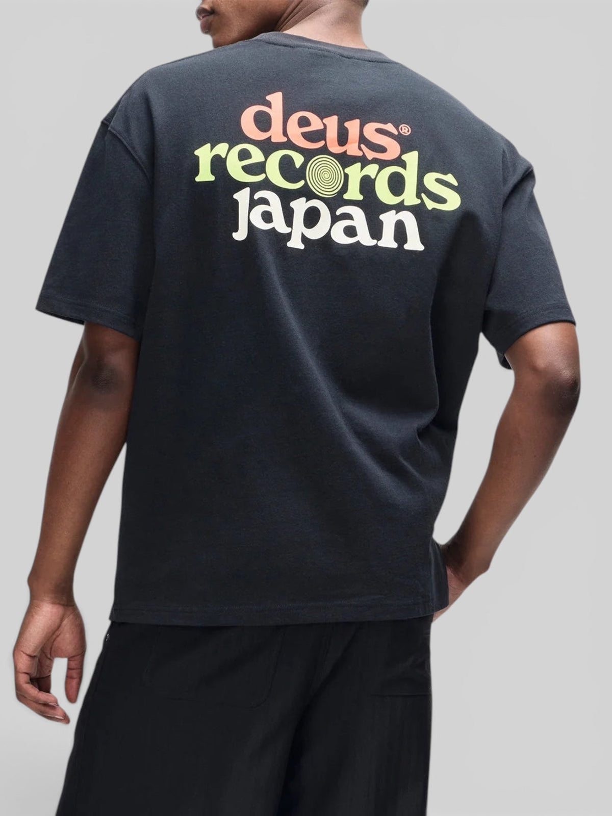 Baffle Haus Strata Tee in black recycled cotton with colorful graphic print on the back, oversized fit.