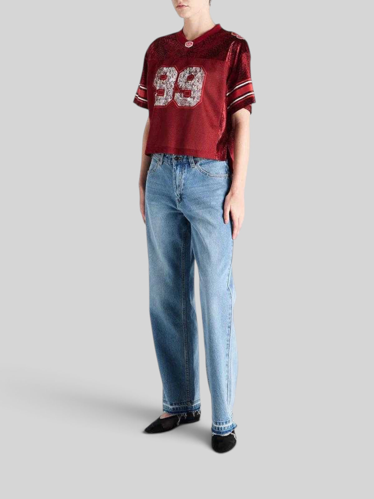 Baffle Haus 20th Century V-neck mesh top in syrah red with white number 99 print, styled with light wash denim jeans.