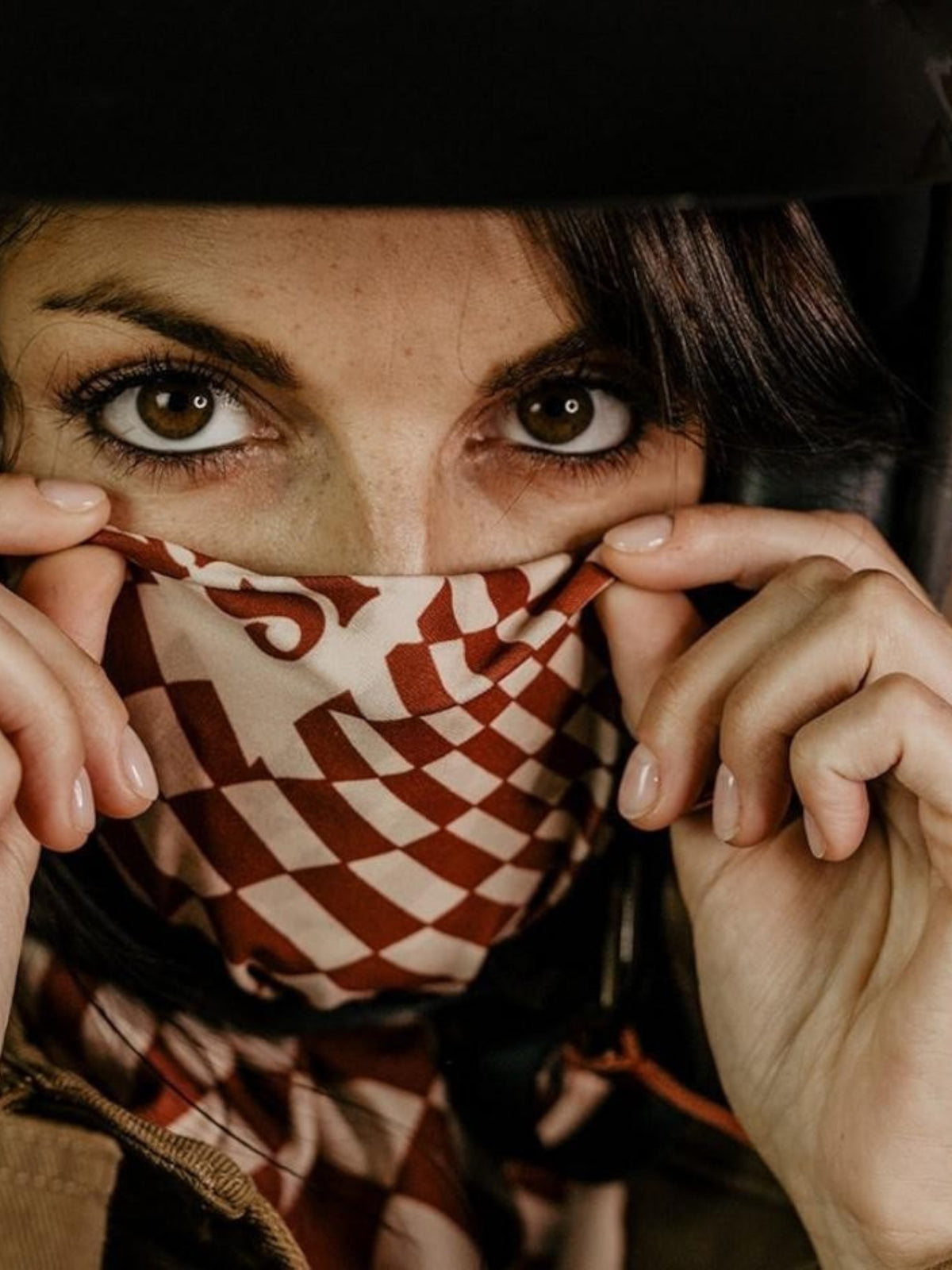 Baffle Haus Petrol Junkies scarf featuring a terracotta and white psychedelic checkerboard pattern worn by a biker
