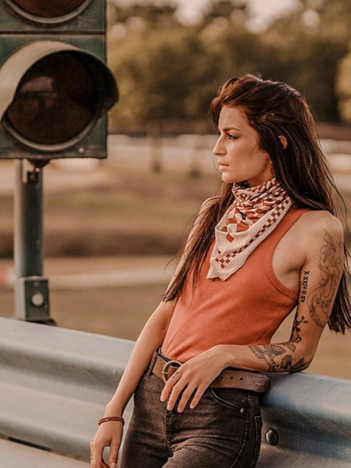 Baffle Haus Petrol Junkies scarf in terracotta with a vintage psychedelic checkerboard pattern worn by a biker