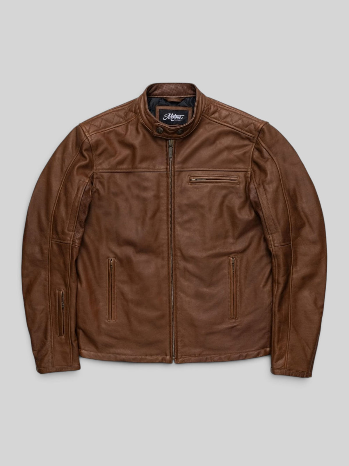 Baffle Haus Motone Revolver tobacco brown cowhide leather motorcycle jacket with diamond-quilted shoulder detailing.