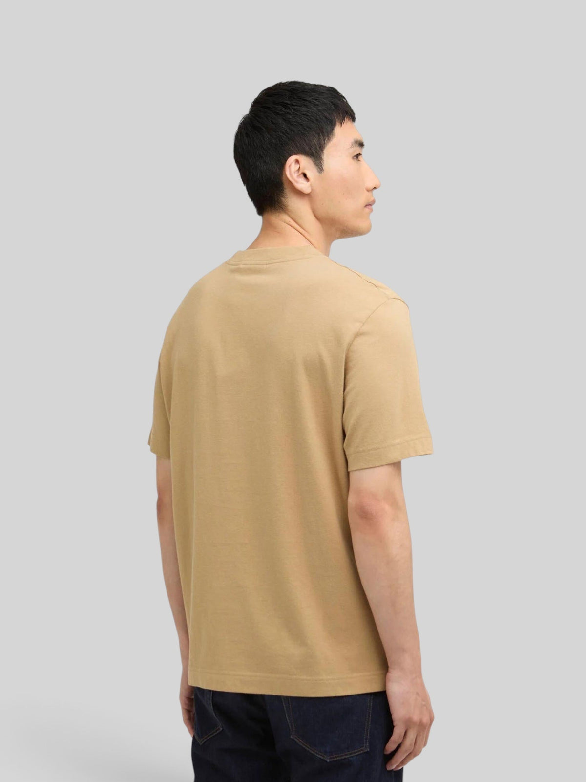 Baffle Haus International Talisman graphic t-shirt in trench beige, worn by a man, back view showing relaxed fit.