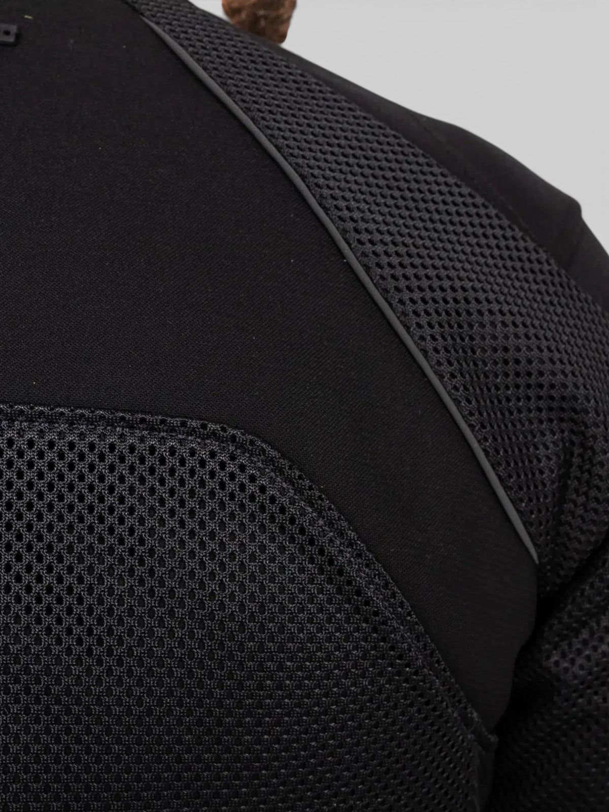 Close-up of Baffle Haus Urbane Pro MK3 black motorcycle jacket showing breathable mesh panels and durable fabric